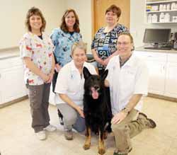 Dr. Sharon Brunzlick, her German shepherd Mac and Dr. Dan Turunen are surrounded by their staff at Spring Brook Veterinary Clinic. Standing from left are Peggy Resch, office manager, Kathy Wendt, assistant, and Betsy Remington, technician.
