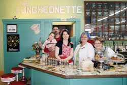 Jenni and Matt Hayek and daughter Perlie, four years old, at The Luncheonette counter located inside Natural Living. Also shown are Barb Rolling and Lynn Jiter.