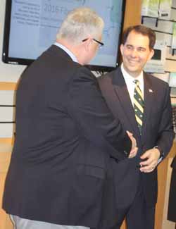 Al Mahnke, CEO of the Wittenberg Telephone Co., welcomes Gov. Scott Walker to the firm's Cirrinity offices on the north side of Antigo this morning. 