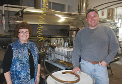 Vicky Adamski and her son, Jim in their sugar bush evaporator room. It's very high tech.
