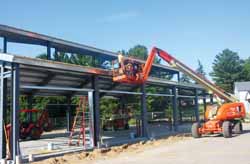 Workmen were on a lift at the new Peaceful Valley Park pavilion Wednesday morning. 