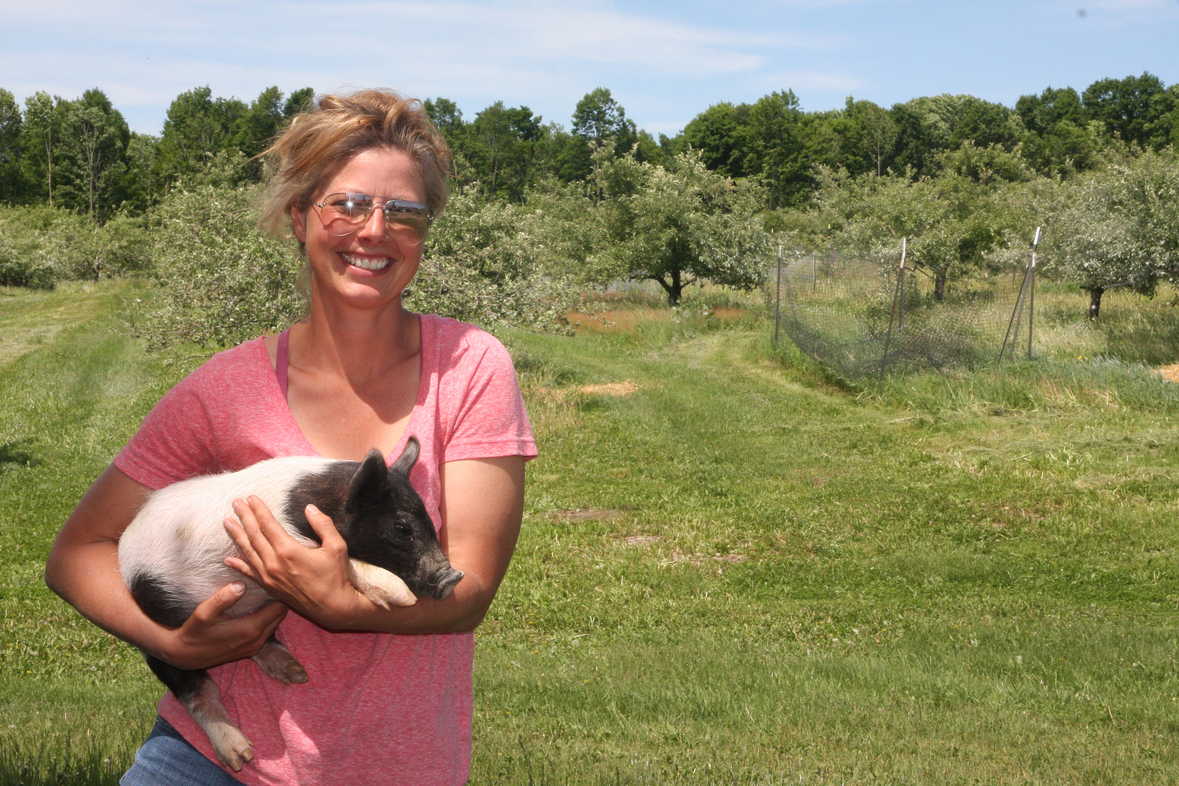 Lisa Rettinger in the Grandview Orchard with Itchy, doing a natural job of improving the grounds.