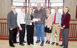 SUCCESS STORY - The resurgence in business in downtown and throughout Antigo is the top story of 2018 locally, and the entrepreneurship grants championed by the city, Langlade County and CoVantage Credit Union is a key component. This picture is from November, when CoVantage refilled the grant coffers with an additional $25,000 donation. From left are City Administrator Mark Desotell, Dan Hansen and Sherry Aulik, representing the credit union, Mayor Bill Brandt, Langlade County Finance Director Pam Resch, Corporation Counsel Robin Stowe and Angie Close, director of the Langlade County Economic Development Corporation.