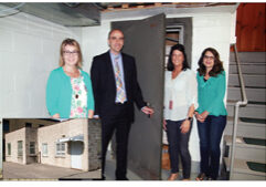 CoVantage staff members, from left, Sherry Aulik, President Charlie Zanayed, Katie Devore and Deb Wirth stand at the safe in the basement of the old Antigo Co-op Oil Association, the original home of CoVantage Credit Union. The inset shows the modest building, which is no longer in use.