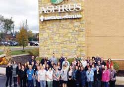 A sampling of Aspirus Langlade Hospital employees celebrate the critical care designation outside the main entrance.