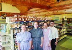 Mervin and Tanya Brubaker with daughters Luanne, at left, and Geneva in the Evergreen Shoppe, which will celebrate its grand opening beginning Friday.