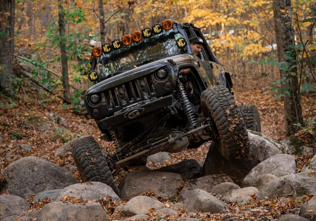 Jeep driver navigating rocks on Langlade County's West Evergreen Off-Highway Motor Vehicle Trail