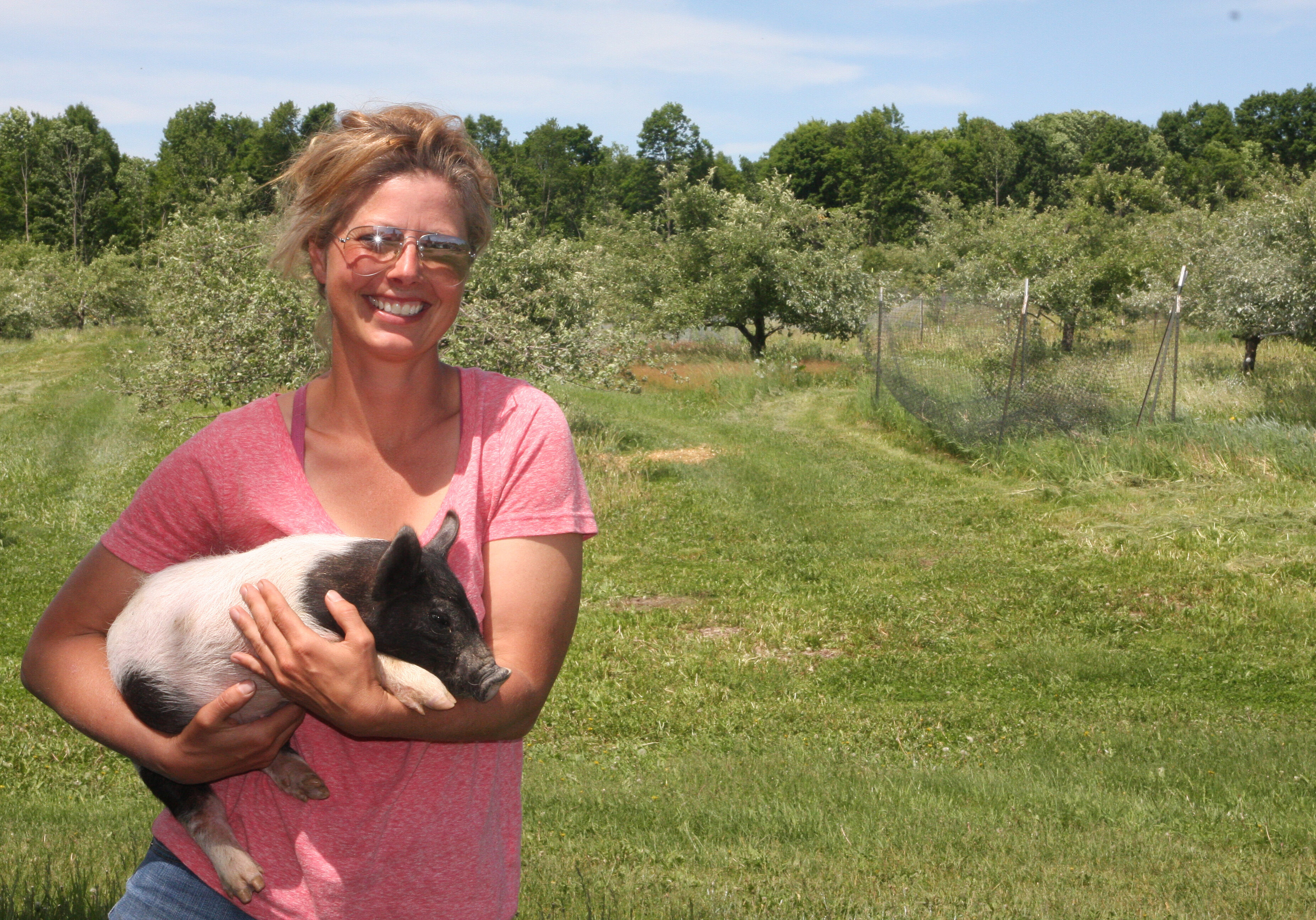 Lisa Rettinger in the Grandview Orchard with Itchy, doing a natural job of improving the grounds.